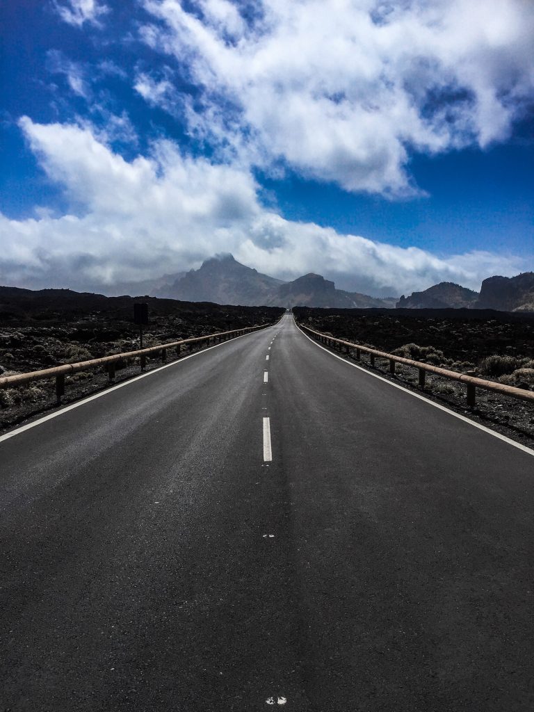 Things to know about Tenerife - roads stretching into the distance with volcanic mountains in the distance.