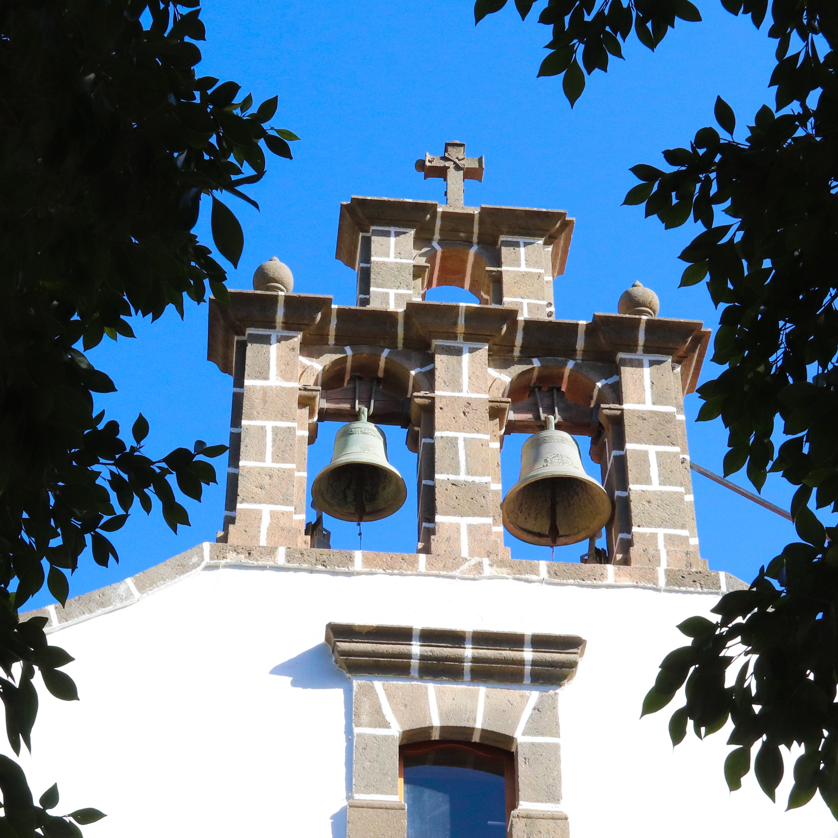 An open belfry of a the little white church in the village of Mogan in Gran Canaria. 